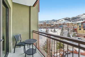 Snow covered back of property featuring a mountain view