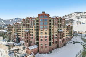 Snow covered building featuring a mountain view