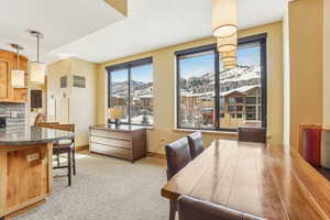 Carpeted dining space with a mountain view