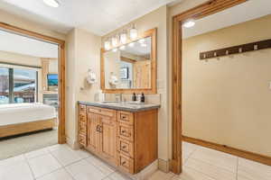 Bathroom featuring vanity and tile patterned floors