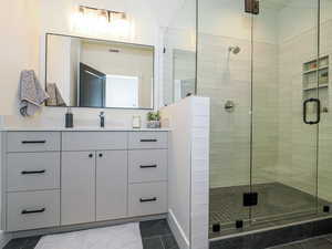 Bathroom with vanity, tile floors, and an enclosed shower