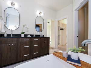 Primary bathroom with double sinks, freestanding tub, separate shower and toilet room