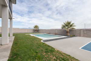 View of swimming pool featuring a yard