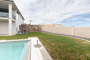 View of yard with a fenced in pool