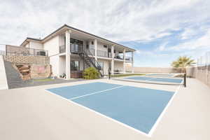 View of sport court featuring basketball court and an outdoor hot tub