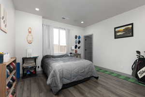 Bedroom with dark wood-type flooring