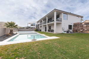 View of swimming pool with a lawn and a patio