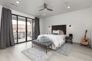 Bedroom featuring ceiling fan, access to exterior, a mountain view, and light hardwood / wood-style flooring