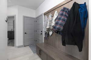 Mudroom featuring light hardwood / wood-style flooring and sink