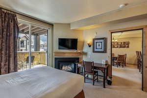 Bedroom featuring light colored carpet and an inviting chandelier