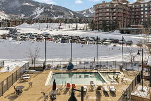 Snow covered pool with a mountain view