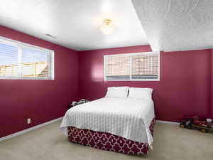 Bedroom featuring light colored carpet