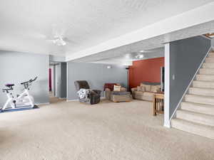 Living room with carpet and a textured ceiling