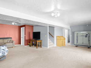 Living room featuring carpet floors and a textured ceiling