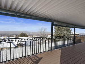 Snow covered deck with a mountain view