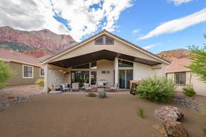 Rear view of property featuring a patio area, a mountain view, and an outdoor hangout area