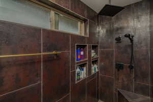 Bathroom with tiled shower and a textured ceiling