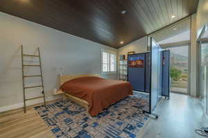 Bedroom with wooden ceiling, lofted ceiling, and light wood-type flooring