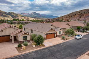 View of front of house with a mountain view and a garage