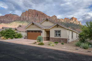 View of front of property with a mountain view and a garage