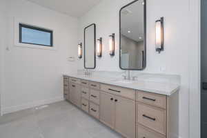 Bathroom featuring double vanity and tile patterned floors
