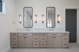 Bathroom featuring double vanity and tile patterned floors