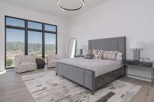 Bedroom featuring wood finished floors and a high ceiling