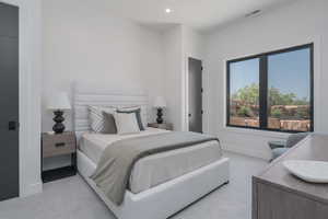 Bedroom with light carpet and recessed lighting