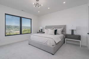 Bedroom with a chandelier, light carpet, and recessed lighting