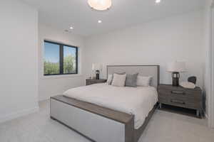 Bedroom featuring light carpet and recessed lighting