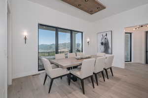 Dining area with a mountain view and light wood finished floors