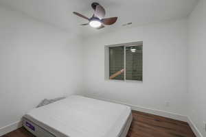 Bedroom featuring ceiling fan and dark wood-type flooring