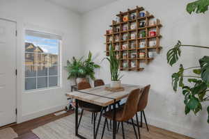 Dining area with dark hardwood / wood-style flooring