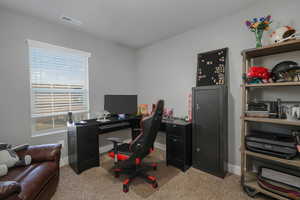 Home office featuring light colored carpet