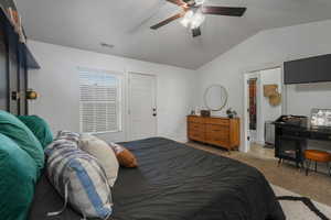 Bedroom featuring light colored carpet, ceiling fan, and lofted ceiling