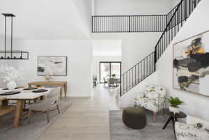 Foyer with a high ceiling and light hardwood / wood-style flooring