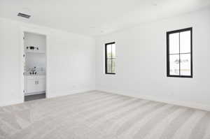 Spare room featuring sink and light colored carpet