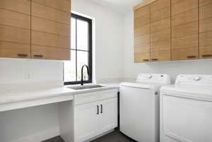 Laundry room with sink, cabinets, plenty of natural light, and independent washer and dryer