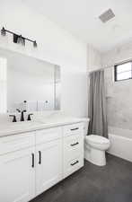 Full bathroom with tile patterned flooring, vanity, shower / bath combination with curtain, and toilet