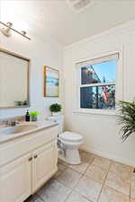 Main level powder bath located off kitchen and dining room