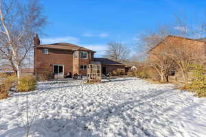 South facing view of property, bricked all the way around home