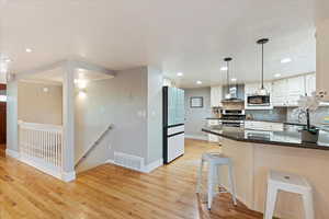 Stairs to basement located between kitchen and living room