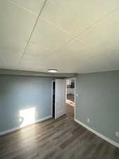 Bonus room with dark hardwood / wood-style flooring