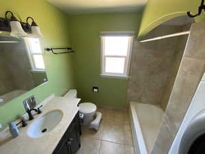 Bathroom with tile patterned floors, vanity, and toilet