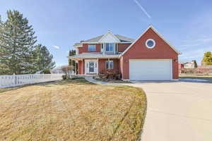 View of front of property with a garage and a front yard