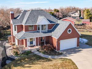 View of front of property with a front lawn and a garage