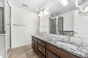 Bathroom featuring vanity and a shower with shower door