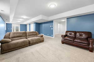 Carpeted living room with a textured ceiling