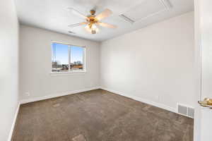 Carpeted empty room featuring ceiling fan