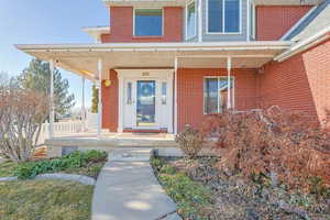 Doorway to property with covered porch